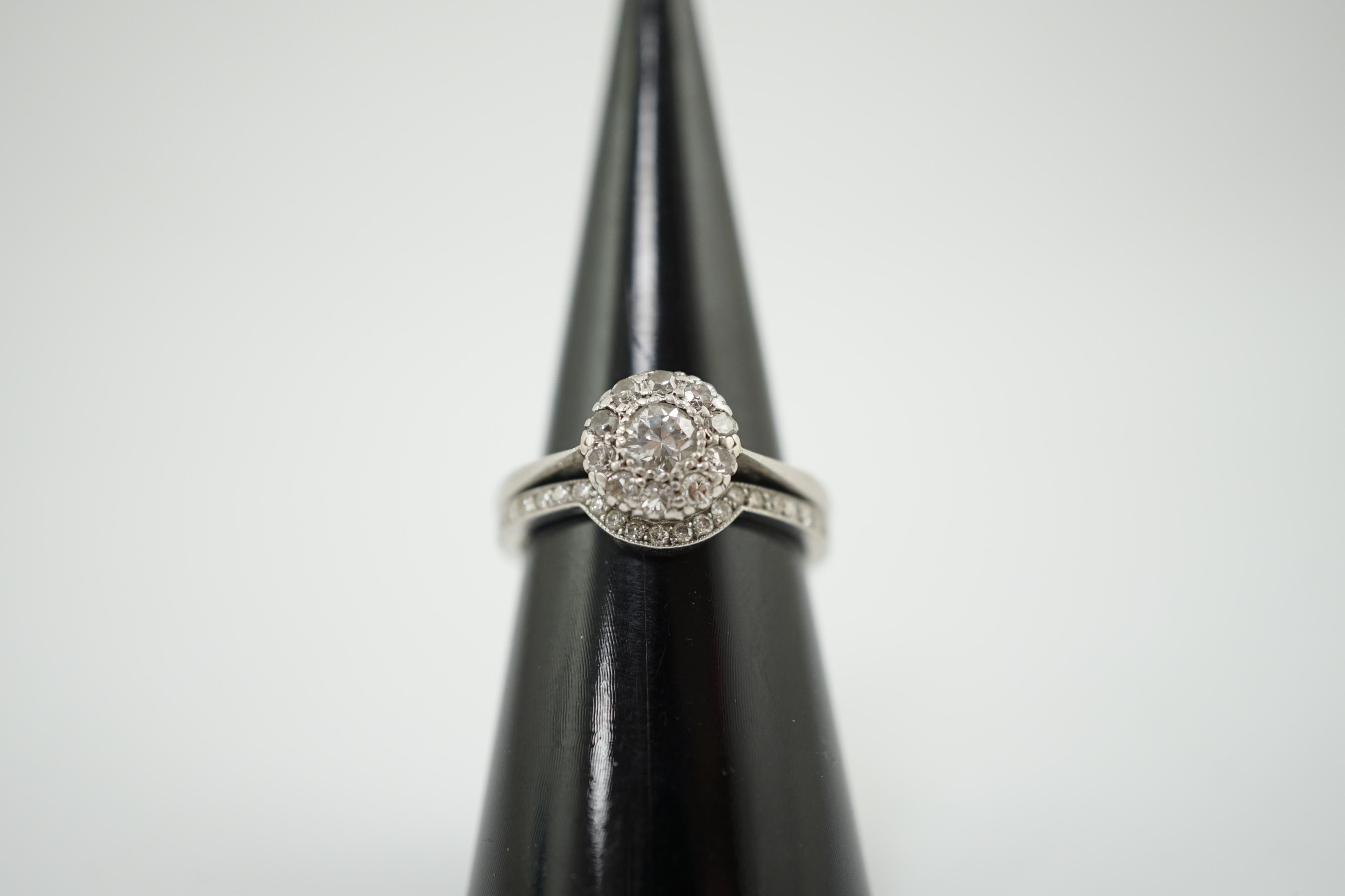 A mid 20th century and later platinum and diamond matched two piece wedding set